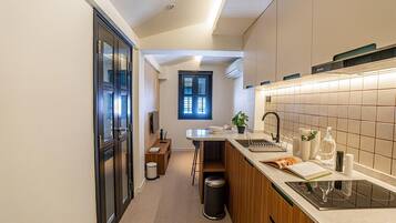 A modern kitchen with a central island, a built-in oven, and a window above the sink.