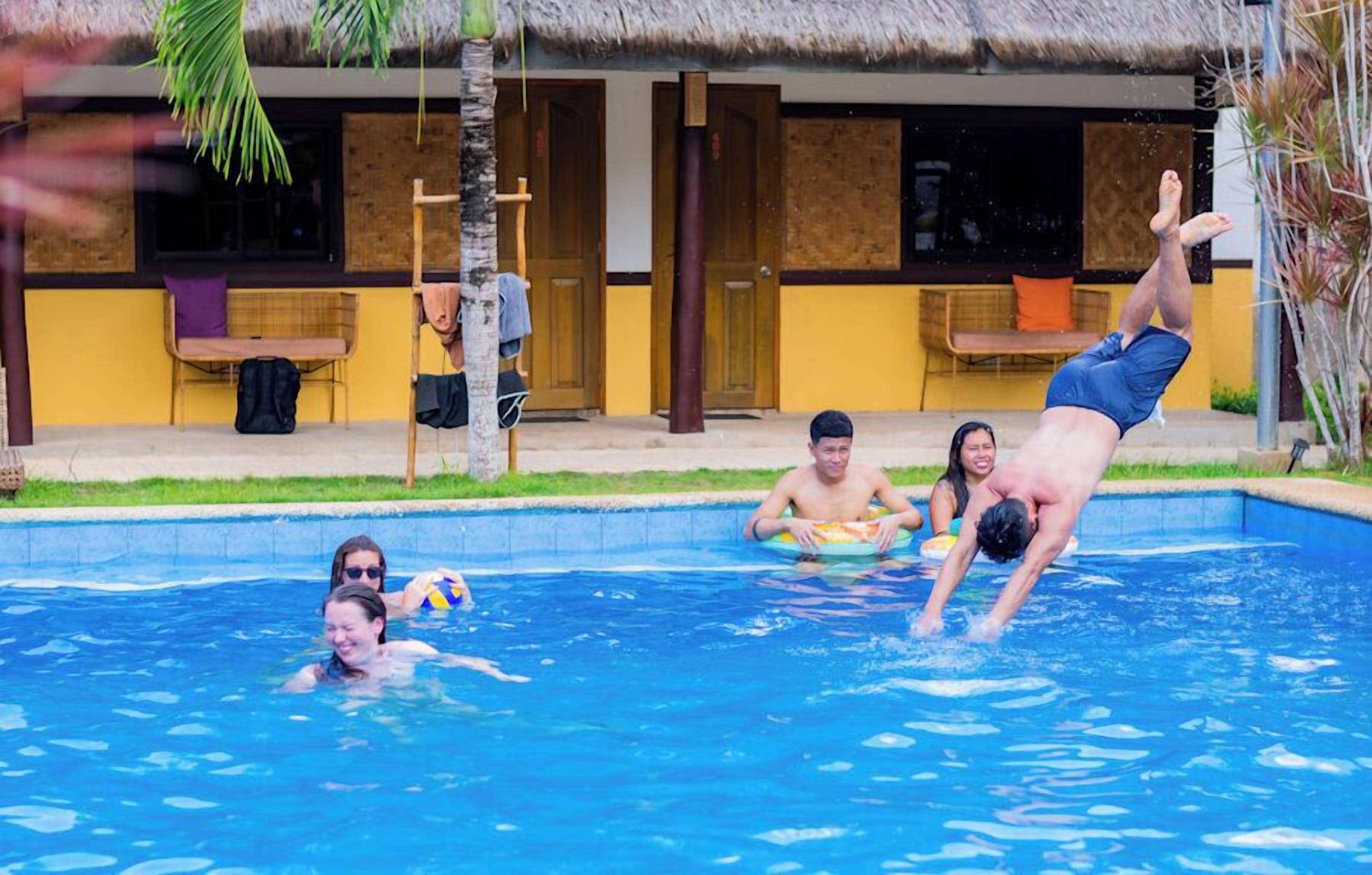 A swimming pool with people engaging in water activities.