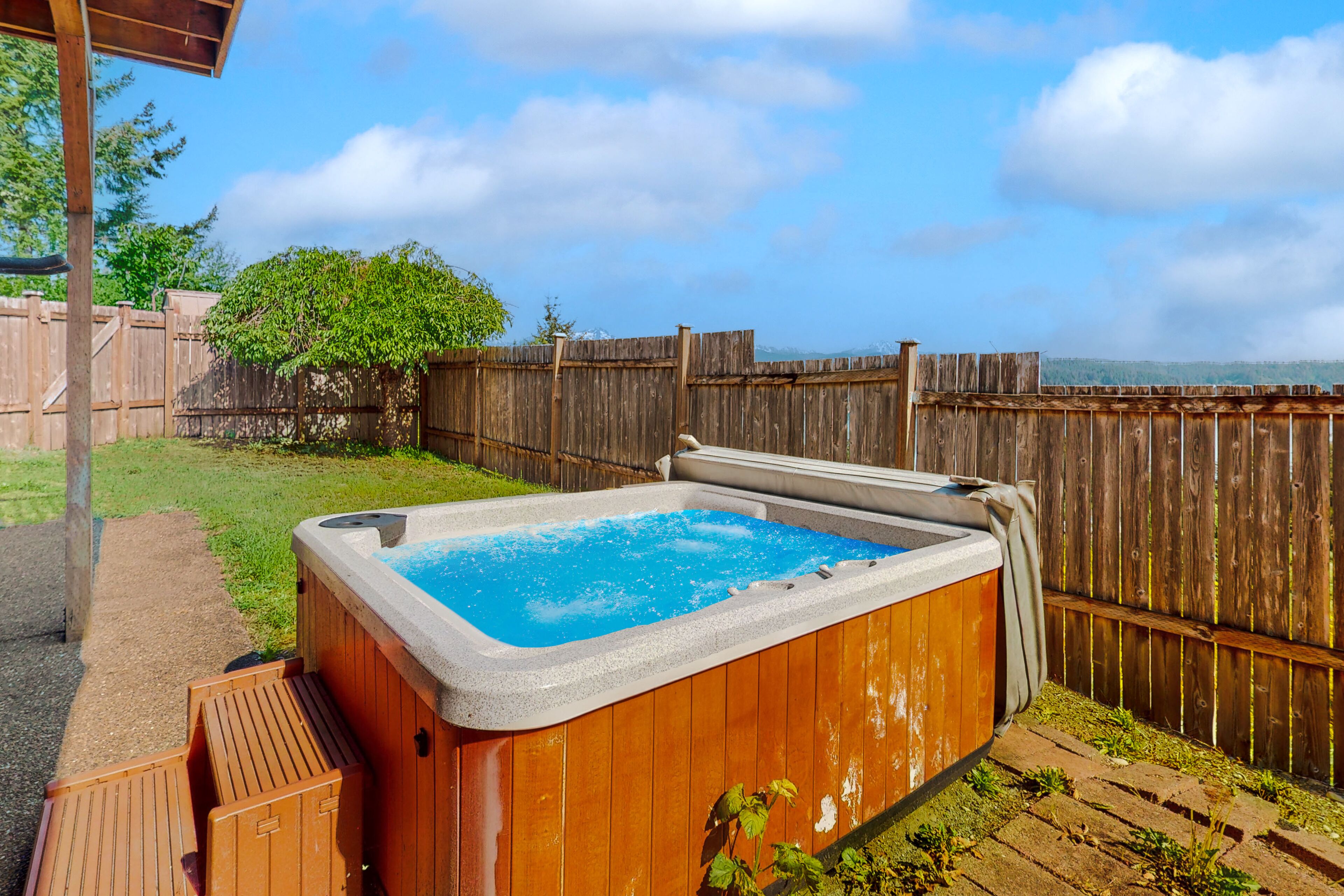 Inviting home with hot tub, water view, fireplace, pool table, & W/D