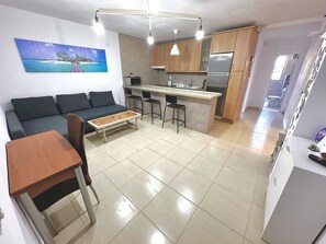 Enjoy a comfortable stay in this apartment with a sofa, coffee table, compact kitchen, and ocean view.