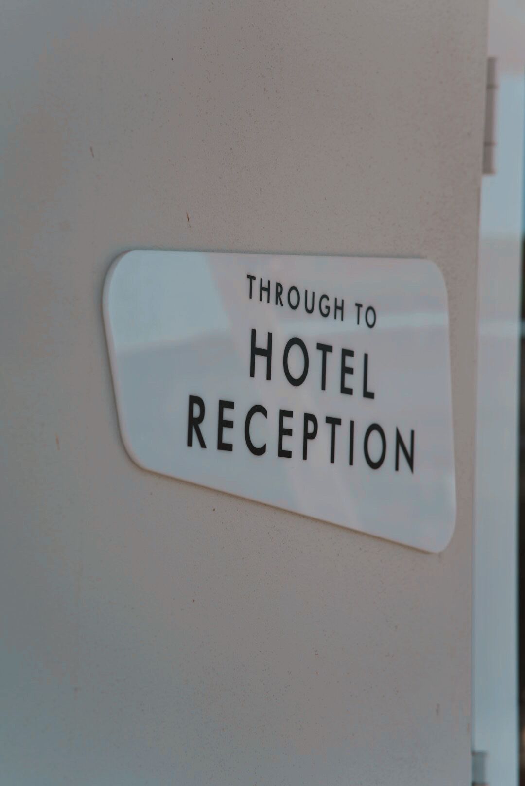 A sign that reads "Through to Hotel Reception."