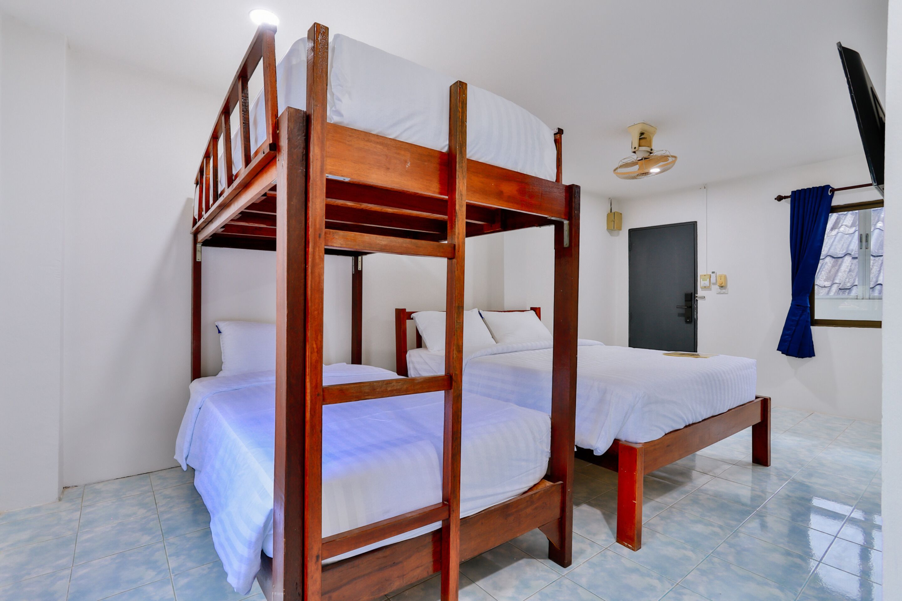 A bunk bed with white bedding and a wooden frame.