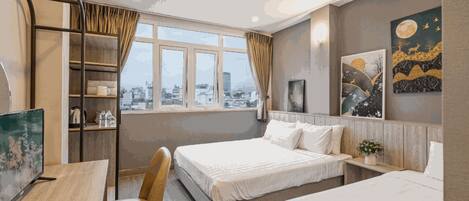 Deluxe Triple Room | Minibar, individually decorated, individually furnished, desk