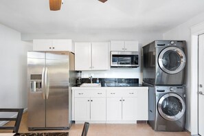 Fridge, microwave, coffee/tea maker, cookware/dishes/utensils