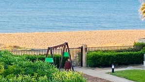 A beach view with a swing set and a fence. - Tierra de Mar 94 by homeprive (Denia)