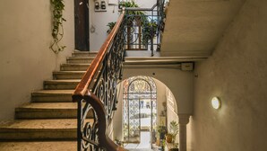 A staircase with a wrought iron railing leading to an arched doorway. - Mediterranean Retreat 2-BR Apt w Rooftop (Tel Aviv)