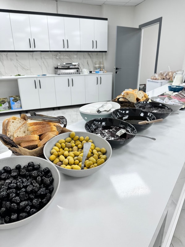 A kitchen counter with various food items and utensils.