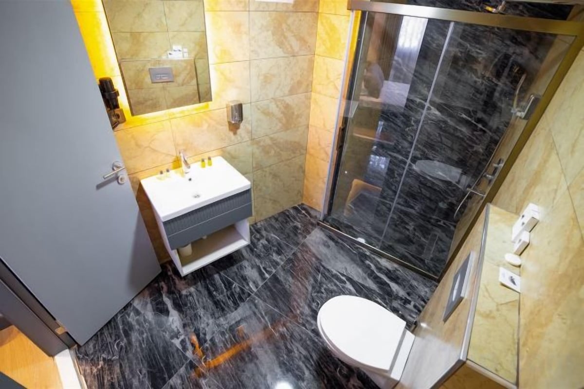 Shower, hair dryer, slippers, towels
