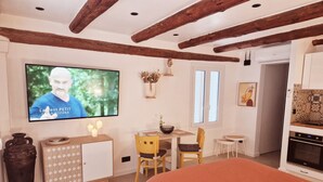 A bedroom with a TV, a bed, a desk, and a chair. - A Casuccia di Mammò (Oletta)