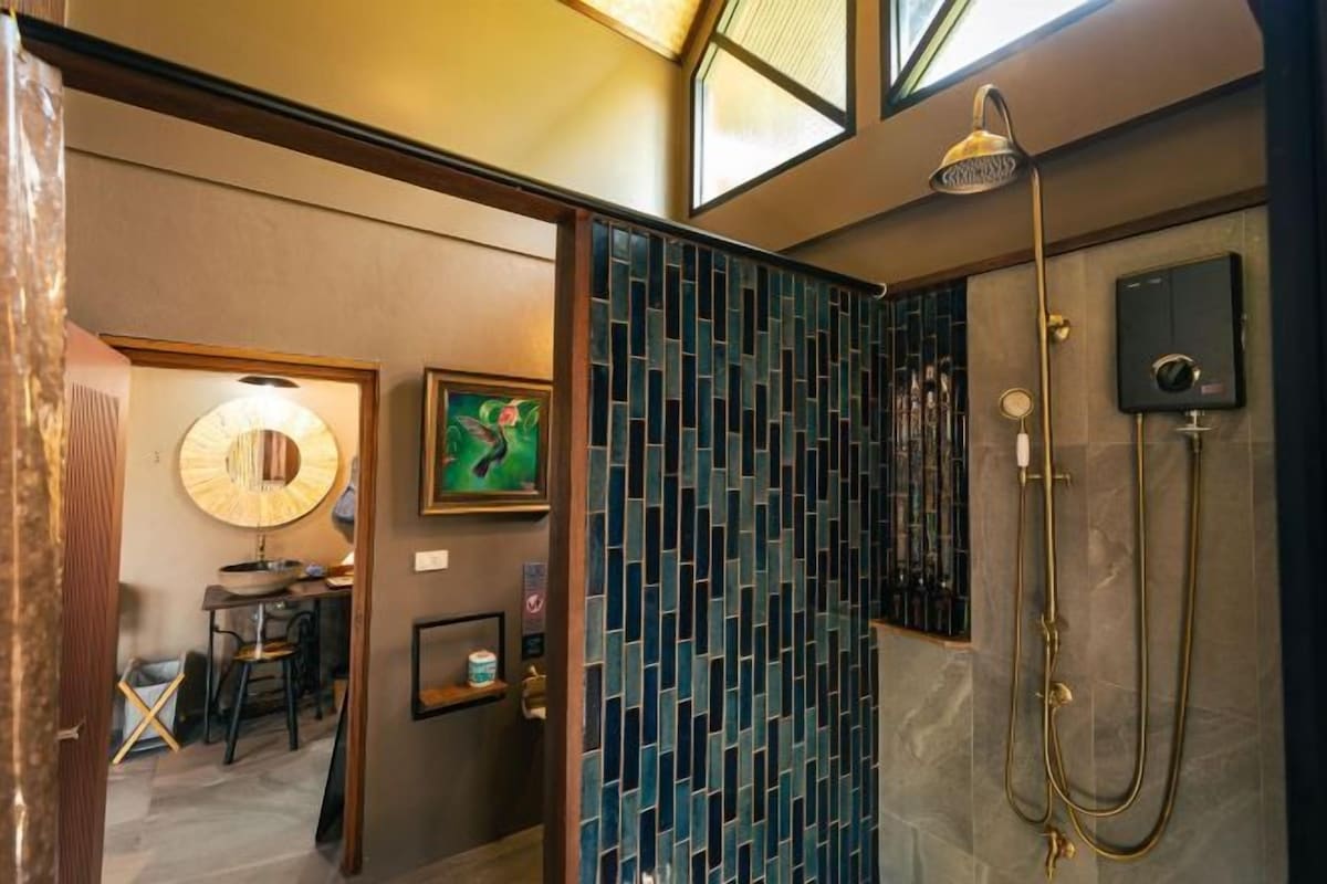 A modern bathroom with a shower, a wall-mounted toilet, and a sink.