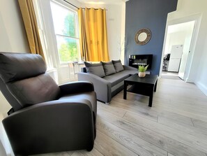 Relax in this stylish living room with a leather armchair, sofa, and coffee table.