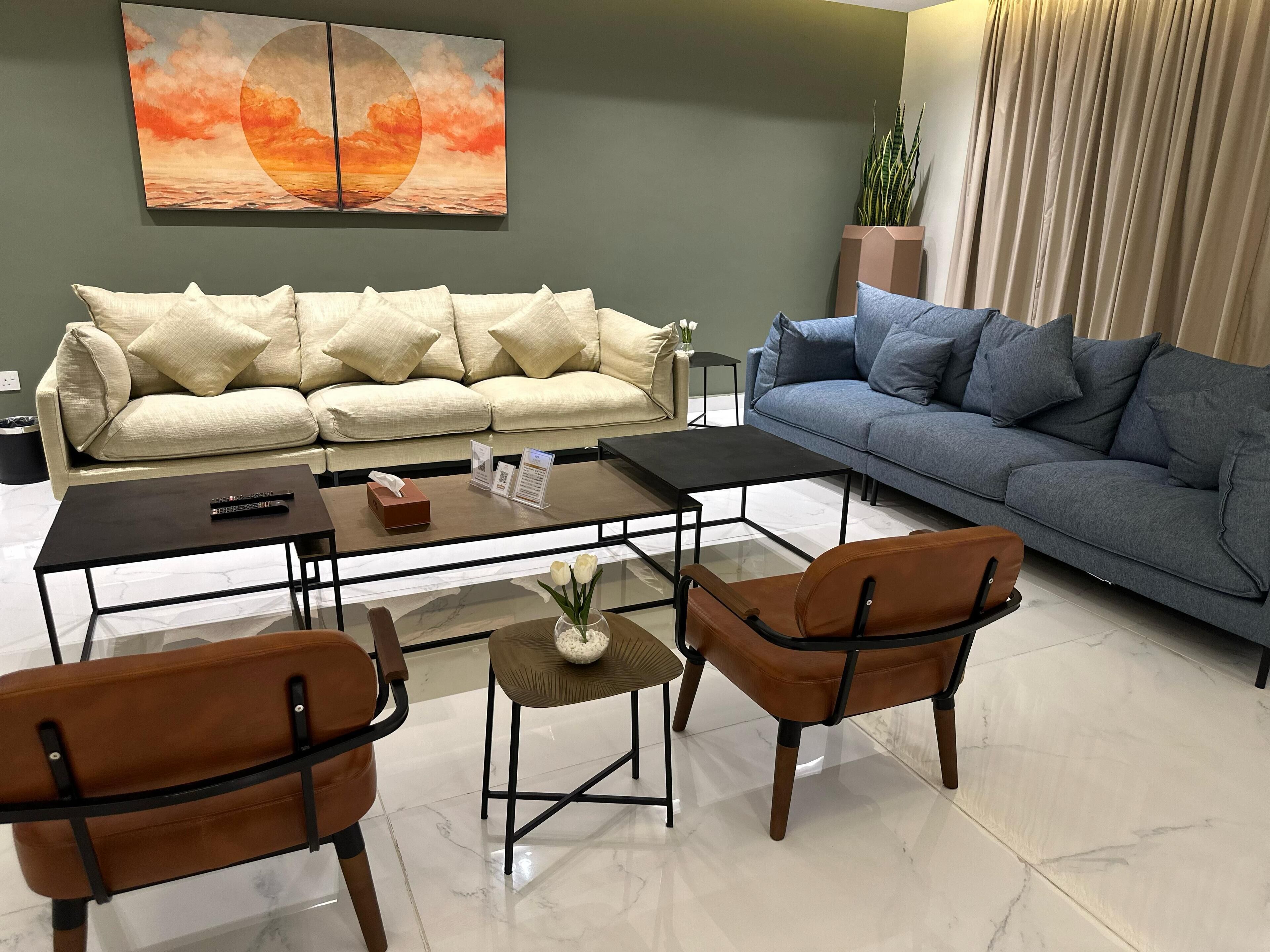 A modern living room with two sofas, a coffee table, and two chairs.