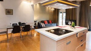 A modern kitchen with an island, dining area, and seating space. - Upscale Kolonaki Experience Elegant Apt (Athens)