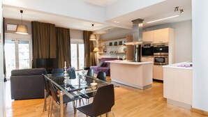 A modern apartment with a dining area, a living room, and a kitchen. - Upscale Kolonaki Experience Elegant Apt (Athens)
