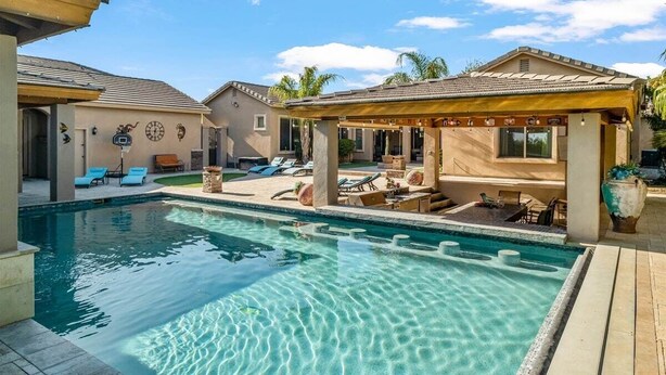 A swimming pool with lounge chairs and a covered seating area. - Welcome to Paradise | Pool Table, Swim Up Bar, Htd Pool, Hot Tub, Casita! (Mesa)