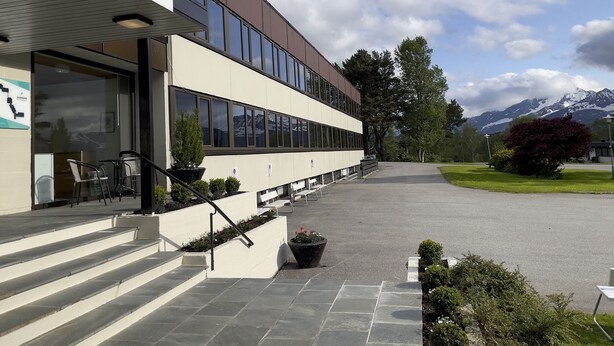 A modern building with a sign reading "BORG SOMMERHOTELL" and a staircase leading to the entrance. - BORG Sommerhotell (Ålesund)