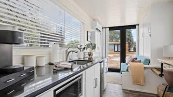 Fridge, microwave, coffee/tea maker, cookware/dishes/utensils