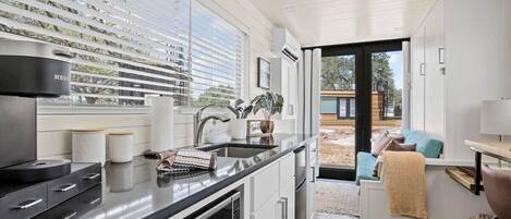 Fridge, microwave, coffee/tea maker, cookware/dishes/utensils