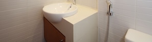 A bathroom with a white sink, a shower, and a toilet. - Relaxing Condo in Al Raha Beach (Abu Dhabi)