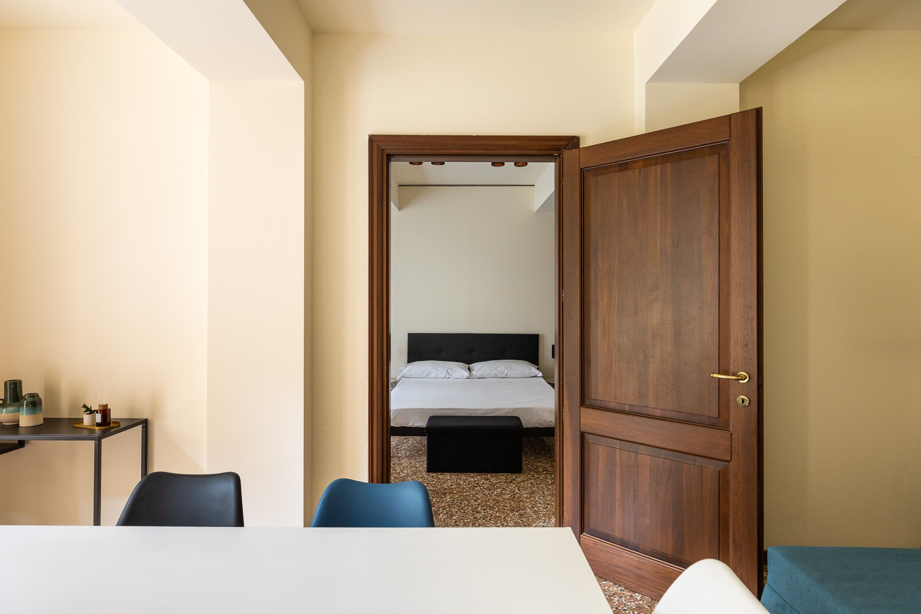 A room with a bed, a desk, and a chair.