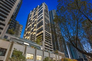 A high-rise building with multiple balconies and a modern architectural design.