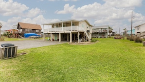 A two-story house with a covered porch and a staircase leading to the upper level.
