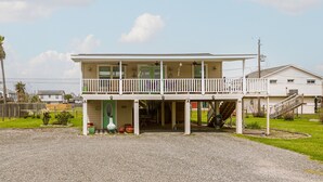 A two-story house with a balcony, a front porch, and a driveway.