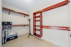 A room with a built-in shelving unit, a wheelchair, and a control panel. - Felicidad: Stunning 3BR Retreat with Private Pool (Oranjestad)