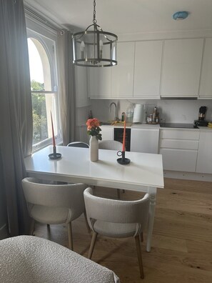 Enjoy cooking and dining in this well-equipped kitchen with a central island, dining table, and sink.