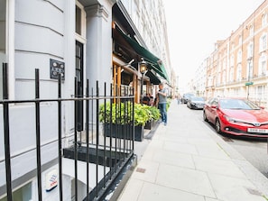 Stylish entrance to Xtal, set amidst a charming urban scene.