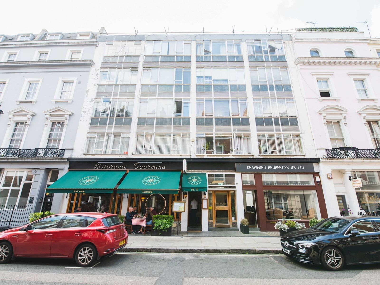 A building with a restaurant named 'Ristorante Taormina' and a property management company 'Crawford Properties UK Ltd'.