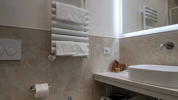 Un bagno moderno con bidet, lavandino e portasciuga.