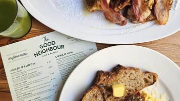 A menu with brunch options and a plate of food with toast and scrambled eggs.