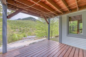 A covered wooden deck with a view of a mountainous landscape. - Luxury Home On Loon Spectacular Mtn Views, walk to ski lodge, Pool/Spa included (Lincoln)