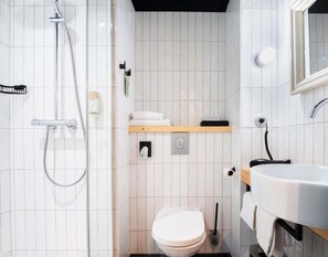 A modern bathroom with a toilet, sink, and shower. - Greet Hotel Cernay Mulhouse (Cernay)