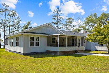 Image of Idyllic waterside home with a hot tub, open-concept layout, W/D, & central AC