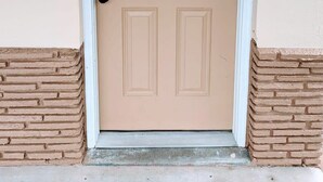 A beige door with a white frame, a number 7, and a keypad lock. - Perfectly Located Studio in MB (Myrtle Beach)