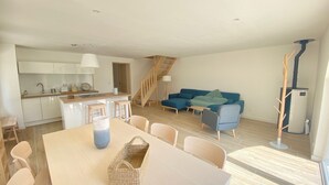 A modern apartment with a kitchen, dining area, and living room.