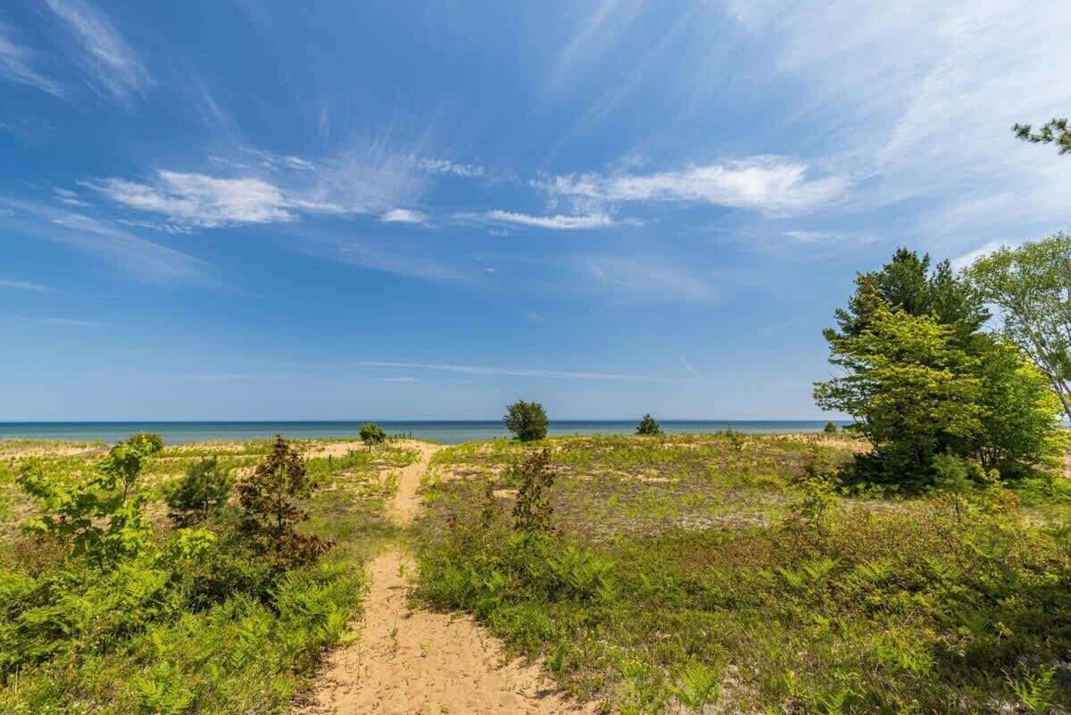 This is your backyard — the sandy shores of Lake Superior's Whitefish Bay, one minute from the front door and often all yours in the morning