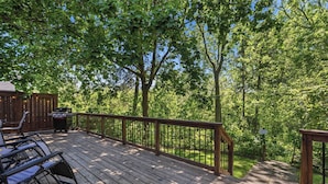 A wooden deck with outdoor furniture, a grill, and a sign indicating a caution area. - Château Ravine, backing onto a beautiful tree-filled ravine  (Niagara-on-the-Lake)