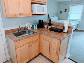 Fridge, coffee/tea maker, cookware/dishes/utensils