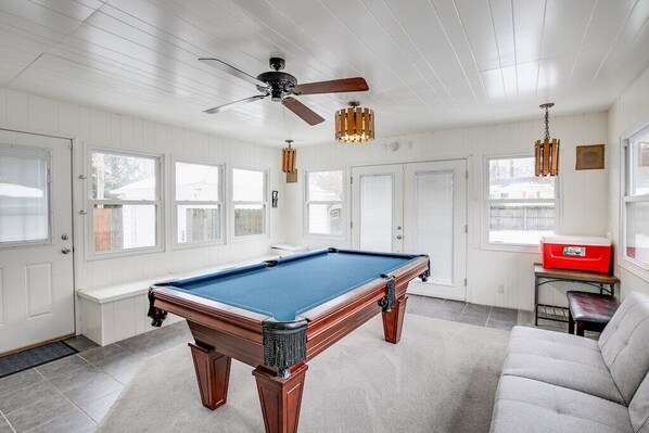 A pool table in a room with white walls and ceiling, a ceiling fan, and a red cooler on a table. - Perfect ND Weekend Space <> 10 Min Walk to Campus (South Bend)