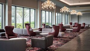 A spacious hotel lobby with large windows, modern chandeliers, and a variety of seating arrangements. - Great Canadian Casino Resort Toronto (Toronto)
