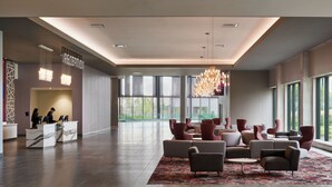 A modern lobby with a reception desk, seating area, and large windows. - Great Canadian Casino Resort Toronto (Toronto)