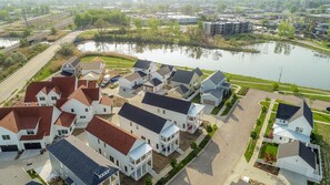 A residential area with houses, a lake, and a bridge. - High End Home in St Joseph, MI with Water Views &  Pool! 7 night minimum. (St Joseph)