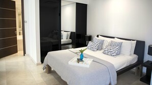 A modern bedroom with a bed, bedside tables, a wardrobe, and a mirror. - luxury Two Bedroom Private Home/ your ideal way to vacation (St george)