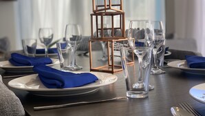 A dining table set with plates, glasses, and a wooden geometric centerpiece. - luxury Two Bedroom Private Home/ your ideal way to vacation (St george)