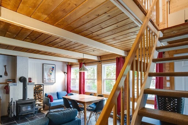 Living room with wood fireplace and dining table (1)