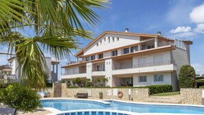 A two-story building with a swimming pool in front. - Gabriel by Interhome (Sant Jordi)