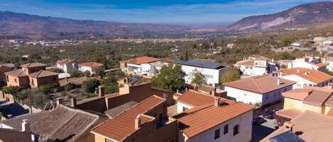 A residential area with houses featuring red-tiled roofs and a mix of architectural styles.